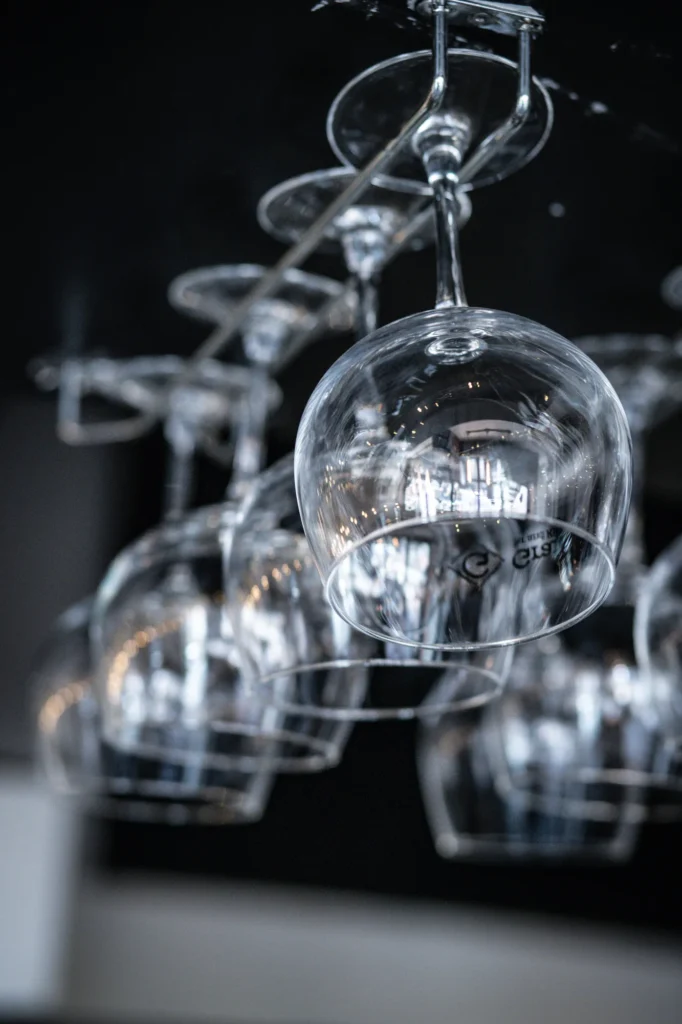 Wine glasses hanging above the bar at KWB