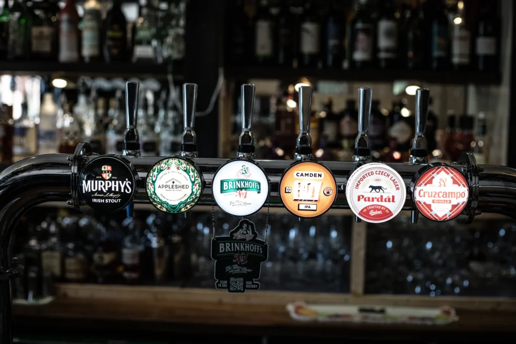 Draught beer taps and pump clips behind the bar at KWB