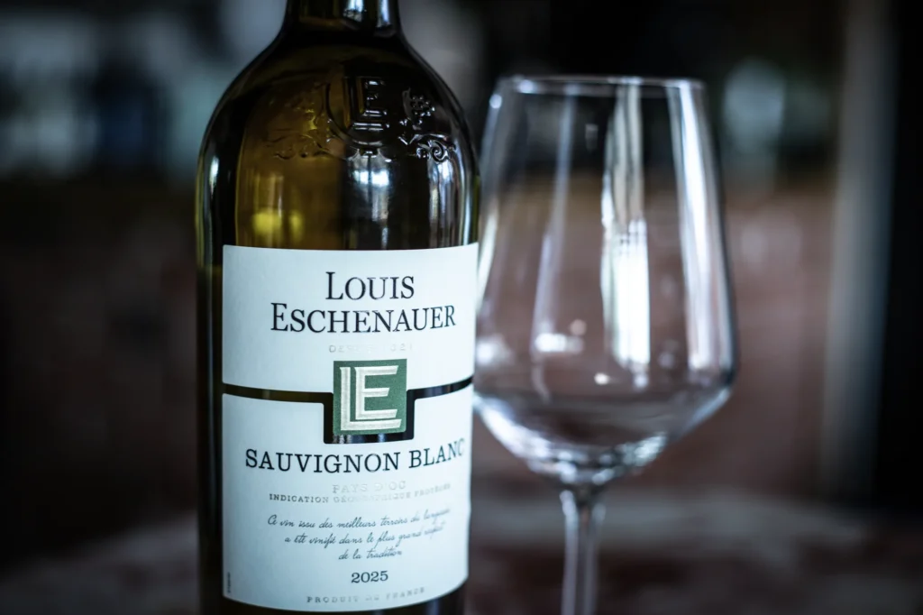 A bottle of Sauvignon Blanc and an empty wine glass on the bar at KWB